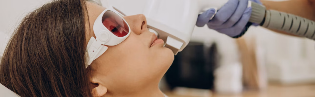 Woman receiving laser treatment with goggles.